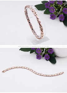 Detail of rose gold stainless steel bracelet with X-shaped links and embedded magnets