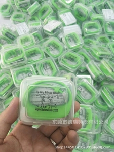 Macro view of neon green silicone pedometer watch in transparent gift box packaging