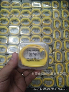 Detailed shot of yellow silicone pedometer watch in clear plastic square packaging