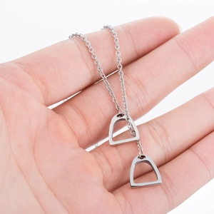 Minimalist stainless steel horseshoe pendant necklace with polished silver stirrup charms