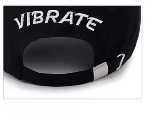 Detail of black baseball cap showing adjustable strap and silver metal buckle