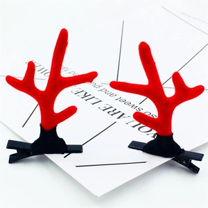 Close-up of red flocked reindeer antler hair clips on a white display card