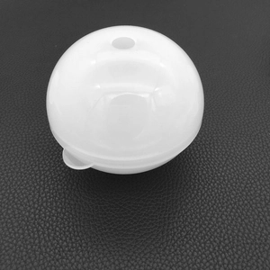 Close-up of translucent white spherical silicone resin mold with injection hole and pull tab