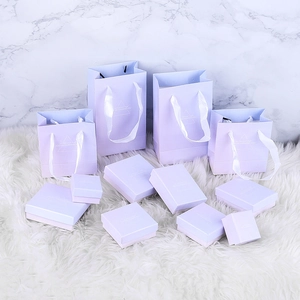 Lavender purple jewelry gift box set and matching tote bag on white faux fur carpet
