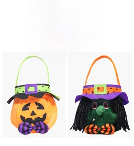 Detail view of pumpkin and witch candy gift bags with purple bows for Halloween