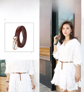 Detail of thin brown leather belt with gold pin buckle for women dresses