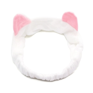 Close-up of soft plush cat ear headband in white and pink for skincare and makeup