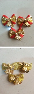 Close-up of mini Christmas bows with golden bells and holly leaves for tree decoration