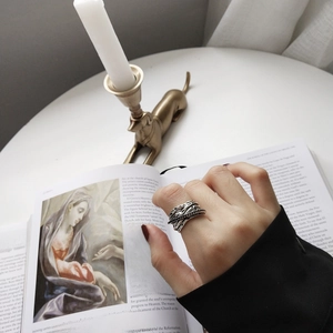 Detail shot of vintage 925 sterling silver ring with woven geometric texture on model's hand