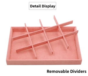 Pink velvet jewelry tray detail featuring 12 slots and removable dividers for rings