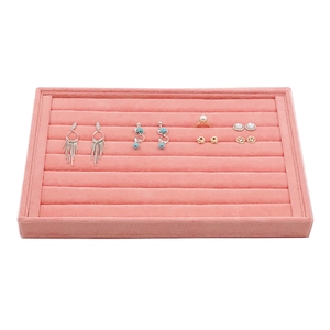 Elegant pink velvet jewelry tray for organizing rings and earrings on white background