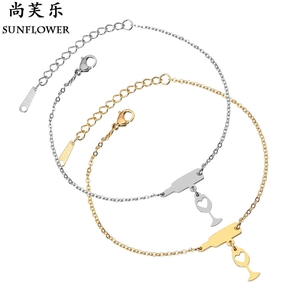 Close-up of stainless steel wine bottle and heart charms on a gold and silver chain