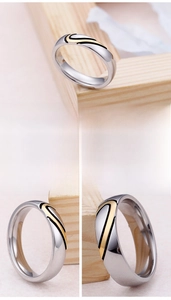 Detail of two-tone wave ring with polished silver and gold stainless steel finish