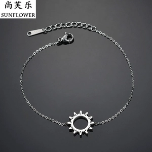 Detailed macro view of silver stainless steel sun charm bracelet with lobster clasp