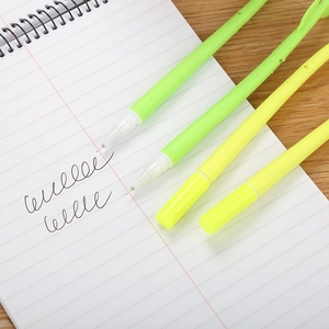 Cute camellia neutral pens with green and yellow barrels on a notebook with hand-drawn lines