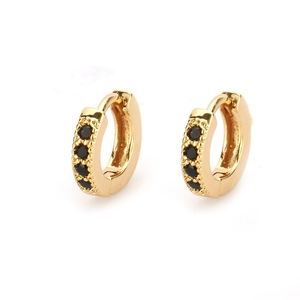 Detail of 18k gold plated huggie earrings featuring four inset round black zircons