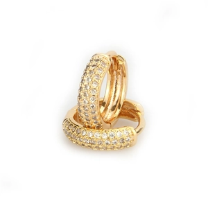 Close-up of gold hoop earrings with multi-row white zircon inlay on white background