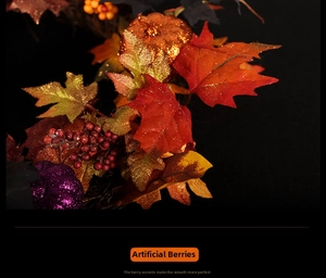 Macro shot of faux red berries and maple leaves on a festive autumn pumpkin wreath