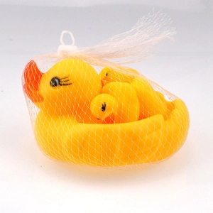 Detail of rubber duck bath toy set with one large and three small ducks in a white mesh bag