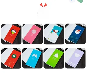 Eight unique Christmas greeting card designs with white envelopes on a rustic wood background