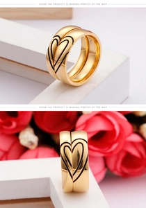 Detailed view of gold couple rings with matching heart engraving and polished finish