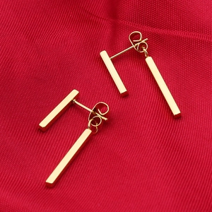 Minimalist 18k gold plated stainless steel double bar drop earrings on red texture