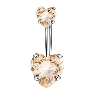 Detailed macro view of champagne heart-shaped zircon stones on a silver navel ring