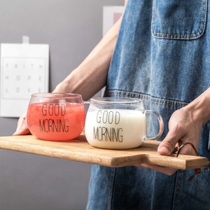 Minimalist Good Morning glass mugs set on wooden tray with milk and fresh juice