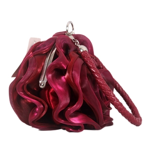Close-up of deep red satin rose evening bag with metallic sheen and woven handle