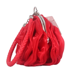 Detail of red silk rose evening bag with elegant petal texture and silver kiss-lock clasp