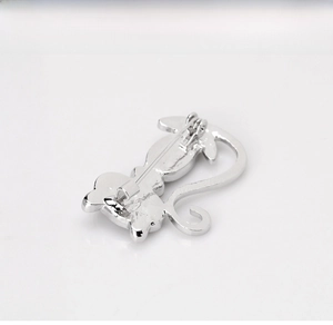 Detail of cute cat brooch showing secure pin mechanism and polished silver finish