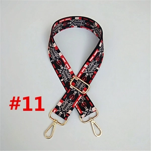 Close-up of adjustable woven shoulder strap with geometric patterns and gold metal buckles