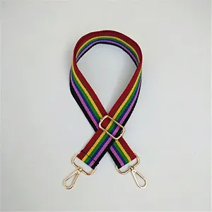 Detail view of adjustable rainbow striped bag strap with gold metal lobster clasps