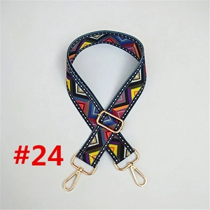 Close-up of geometric ethnic pattern bag strap with gold metal hooks and adjustable buckle