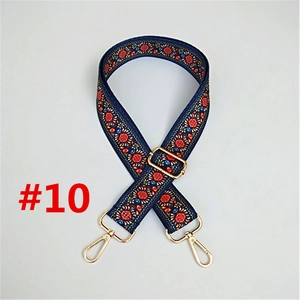 Detail of blue floral ethnic bag strap with adjustable gold lobster clasp hardware