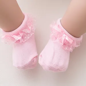 Pink infant lace socks featuring polka dot trim and satin bows for newborns and babies
