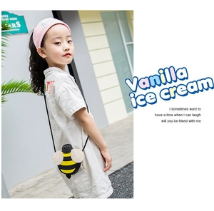 Detail of a cute bee-shaped crossbody bag for girls with yellow and black stripes
