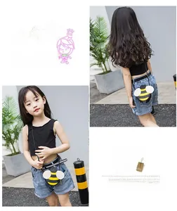 Detail of cute yellow bee crossbody bag with 3D wings and striped PU material for girls
