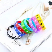 Close-up of colorful silicone rings with star and peace signs on a fashion magazine