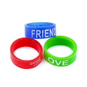 Three colorful silicone rings in blue, red, and green with motivational words