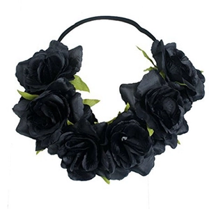 Close-up of black artificial rose headband with elastic band and green leaf details