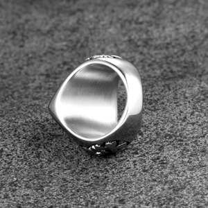 Vintage stainless steel skull ring with embossed cross patterns and brushed metal interior