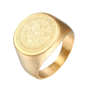 Brushed golden stainless steel compass signet ring for men on white background