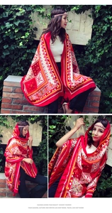 Detail of red Bohemian style shawl with geometric patterns and fringe tassels