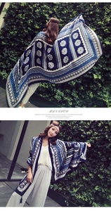 Detail of bohemian blue shawl with ethnic geometric patterns and tassel fringe finish