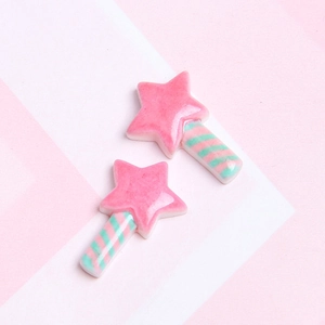 Close-up of pink and green resin star wands for DIY phone cases and crafts decorations