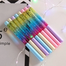 Close-up of glitter quick-sand gel pens with transparent barrels and colorful caps