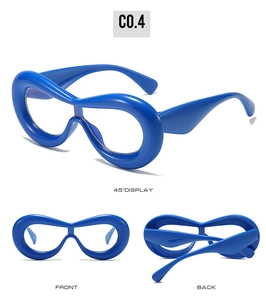 Macro detail of glossy blue oversized eyewear frames showing front and side perspectives