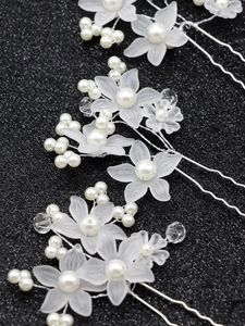 Detail of silver bridal hair pin with frosted flowers, white pearls and crystal beads