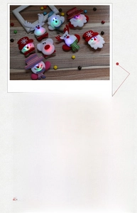 Detail of Christmas LED brooches showing Santa and reindeer designs on wood background